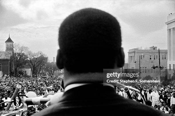 Dr Martin Luther King Jr seen close from the rear, speaking to 25,000 civil rights marchers in front of the Alabama state capital building, at the...