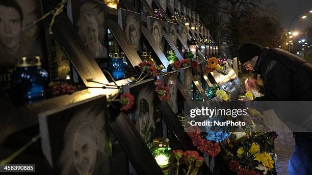 Man places a candle in honor of the &quot;Nebesna Sotnya&quot; on the anniversary of the Euromaidan protests which led to the deaths of at least 79...