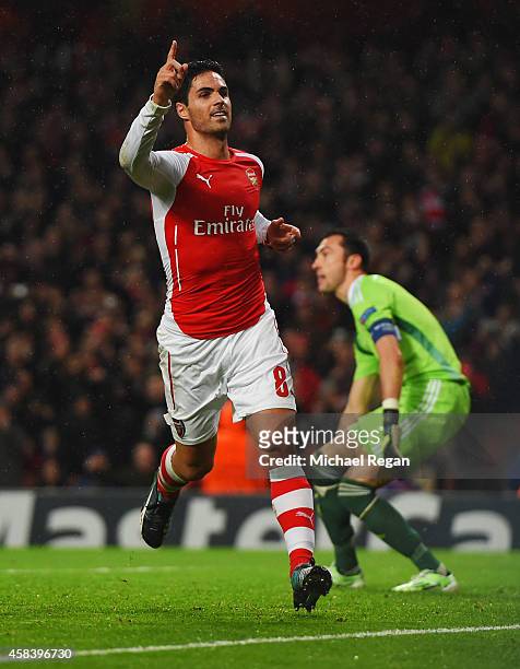 Mikel Arteta of Arsenal celebrates as he scores their first goal from the penalty spot during the UEFA Champions League Group D match between Arsenal...