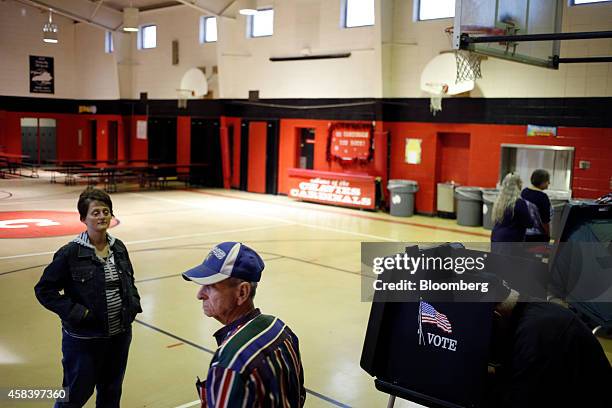 Voter, right, casts his ballot a polling station in the gymnasium at Chavies Elementary School in Hazard, Kentucky, U.S. On Tuesday, on Nov. 4, 2014....