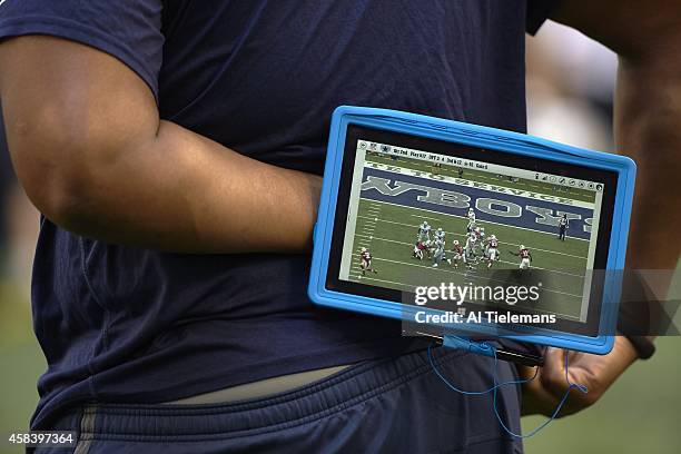 Closeup of Dallas Cowboys coach holding Microsoft Surface tablet on sidelines during game vs Arizona Cardinals at AT&T Stadium. Arlington, TX...