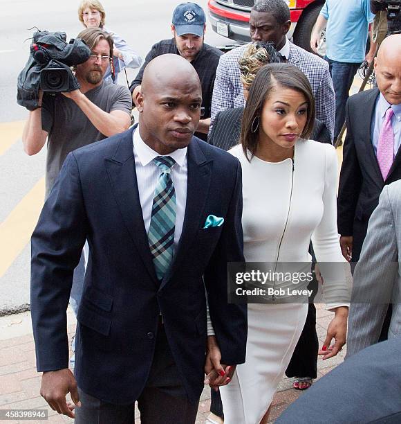 Football running back Adrian Peterson of the Minnesota Vikings arrives for a court hearing on charges of child abuse at the Montgomery County...