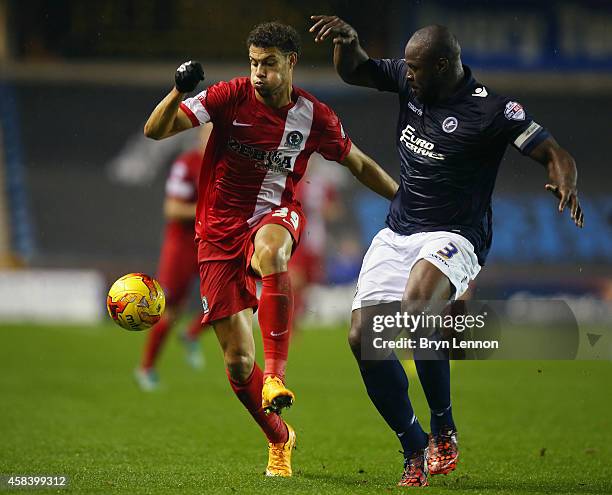 Rudy Gestede of Blackburn Rovers is tackled by Danny Shittu of Millwall during the Sky Bet Championship match between Millwall and Blackburn Rovers...