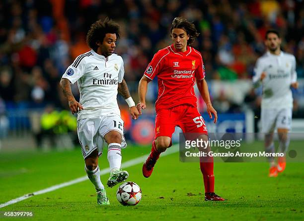 Marcelo of Real Madrid CF is closed down by Lazar Markovic of Liverpool during the UEFA Champions League Group B match between Real Madrid CF and...