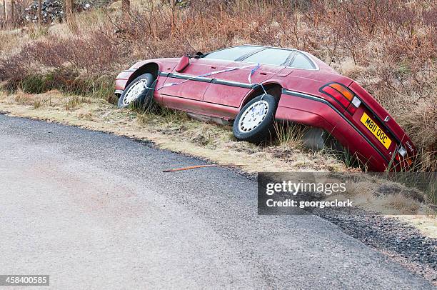 crashed car in a ditch - road accident uk stock pictures, royalty-free photos & images