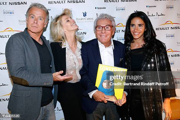 Daniel Lorieux and his companion Laura Restelli standing between Humorist Franck Dubosc and his wife Daniele Dubosc attend Jean-Daniel Lorieux signs...