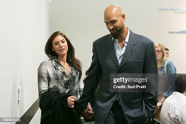 Hope Solo and husband Jerramy Stevens exit the court room at Kirkland Municipal Court on November 4, 2014 in Kirkland, Washington. Solo is charged...