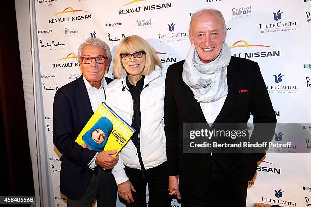 Jean-Daniel Lorieux, Mireille Darc and her husband Pascal Desprez attend Jean-Daniel Lorieux signs his Book 'Sunstroke' at the Art Bookshop of the...