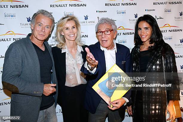 Daniel Lorieux and his companion Laura Restelli standing between Humorist Franck Dubosc and his wife Daniele Dubosc attend Jean-Daniel Lorieux signs...