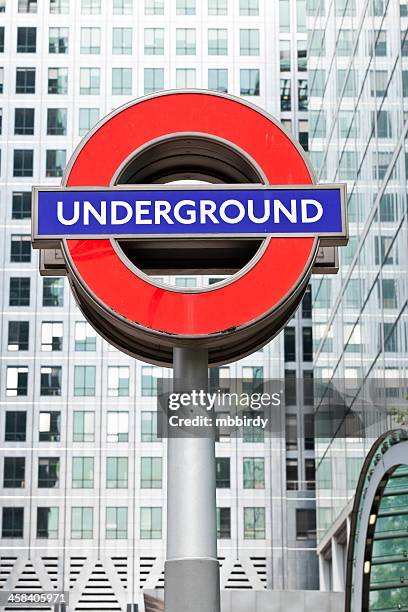 london underground famous sign in canary wharf - underground sign stock pictures, royalty-free photos & images