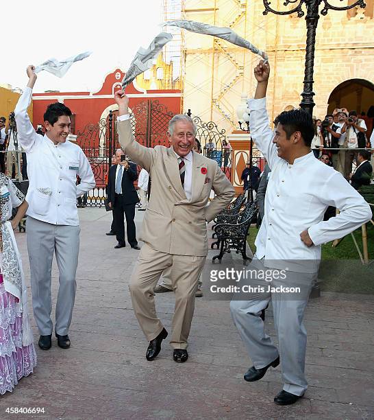Prince Charles, Prince of Wales takes part in traditional Mexican clog dancing in Zocalo Square on November 4, 2014 in Campeche, Mexico. The Royal...