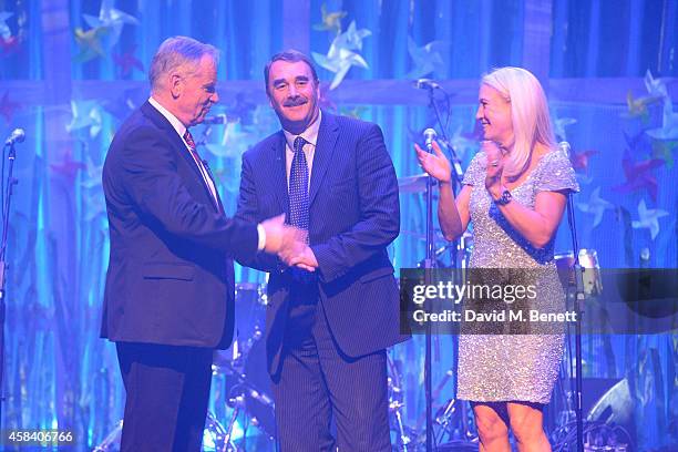 Lord Jeffrey Archer, Nigel Mansell and Clea Newman on stage at the second annual SeriousFun Network Gala at at The Roundhouse on November 4, 2014 in...