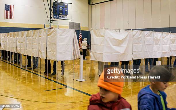 Students in grades 1-2 at the Friends School on Mackworth Island take a tour of Falmouth High School as the voting booths remain nearly full in...