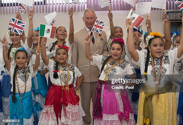 Prince Charles, Prince of Wales poses with dancers at the Women's Justice Centre Capeche on November 4, 2014 in Campeche, Mexico. The Royal Couple...