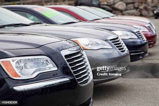 chrysler vehicles in a row at car dealership - chrysler stock pictures, royalty-free photos & images