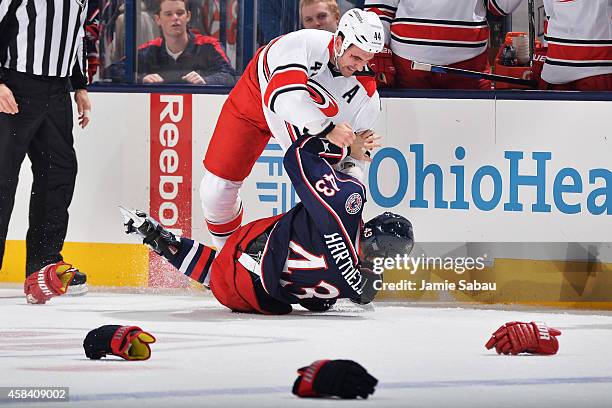 Jay Harrison of the Carolina Hurricanes takes down Scott Hartnell of the Columbus Blue Jackets during a fight in the first period on November 4, 2014...