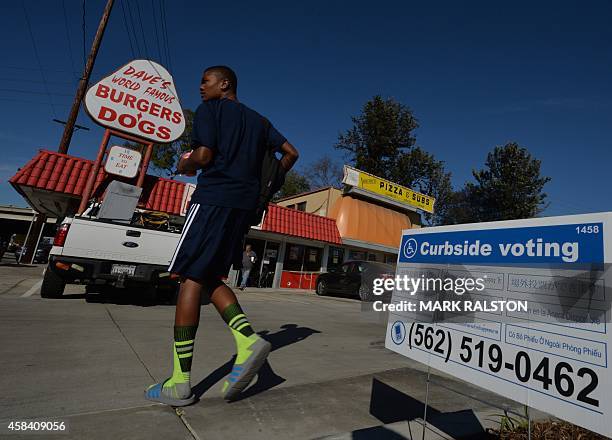 Man arrives to vote at the Avenue 3 Pizza shop, employed as a polling station during midterm elections, in Long Beach, California on November 4,...