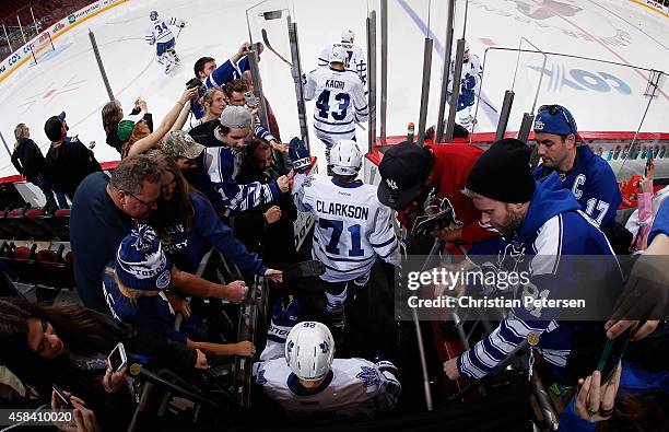 Nazem Kadri, David Clarkson and Daniel Winnik of the Toronto Maple Leafs take the ice for warm ups to the NHL game against the Arizona Coyotes at...