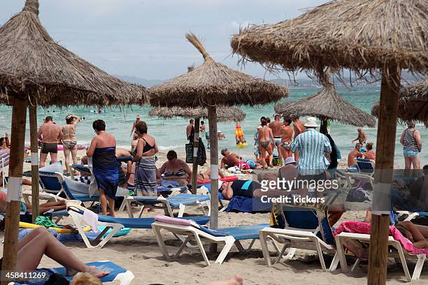 crowded beach at can picafort, spain - skimpy bathing suits stock pictures, royalty-free photos & images