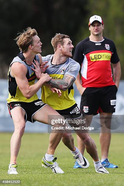 Assistant coach Aaron Hamill watches Saints newest recruit Tim Membrey compete for the ball against Daniel Markworth during a St.Kilda Saints AFL...