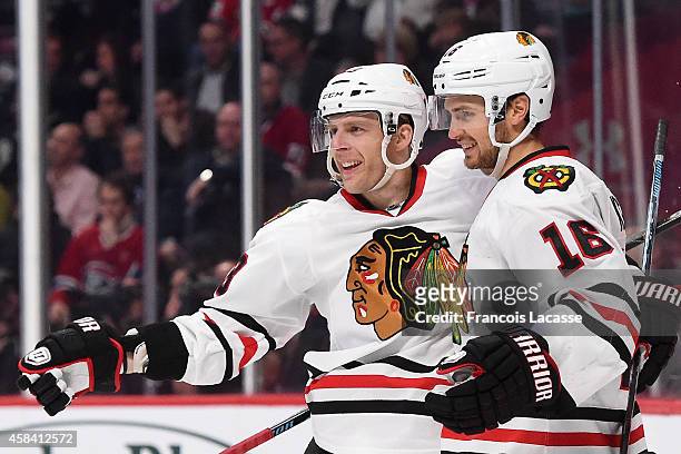 Marcus Kruger of the Chicago Blackhawks celebrates with Kris Versteeg after scoring a goal against Montreal Canadiens in the NHL game at the Bell...