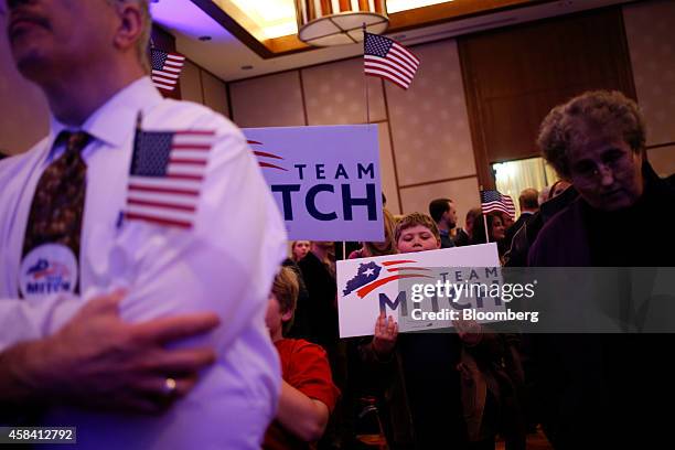 Supporters of Senate Minority Leader Mitch McConnell hold signs as they watch election results at a Republican Party of Kentucky election night party...