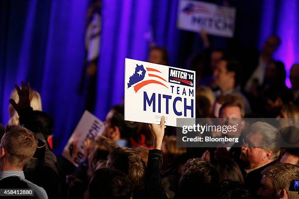 Supporter of Senate Minority Leader Mitch McConnell holds up a sign as McConnell speaks on stage at a Republican Party of Kentucky election night...