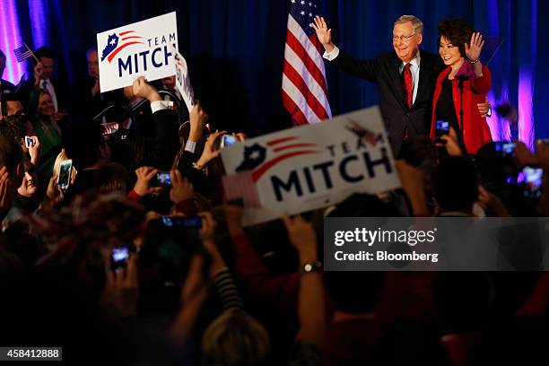 Senate Minority Leader Mitch McConnell, a Republican from Kentucky, second from right, waves to supporters alongside his wife Elaine Chao at a...