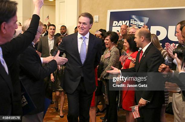 Republican U.S. Senate candidate David Perdue enters his election party to celebrate his win at the InterContinental Buckhead November 4, 2014 in...