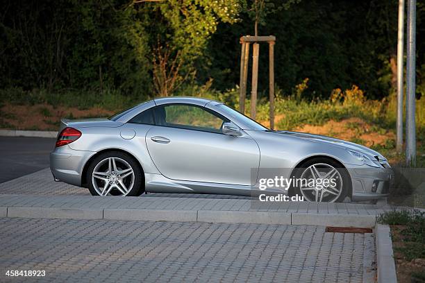 mercedes-benz slk sports car on public parking place - mercedes benz stock pictures, royalty-free photos & images