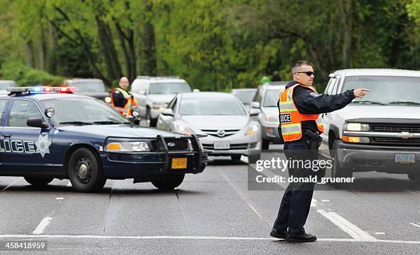 police officers directing traffic - verkeerspolitie stockfoto's en -beelden