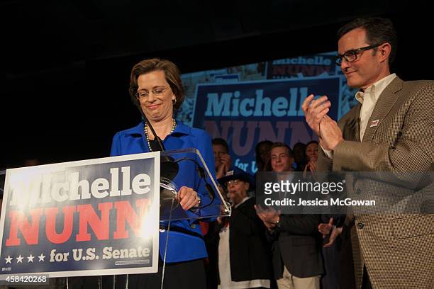 Georgia Democratic U.S. Senate candidate Michelle Nunn with husband, Ron Martin, makes a concession speech to supporters gathered at the Hyatt...
