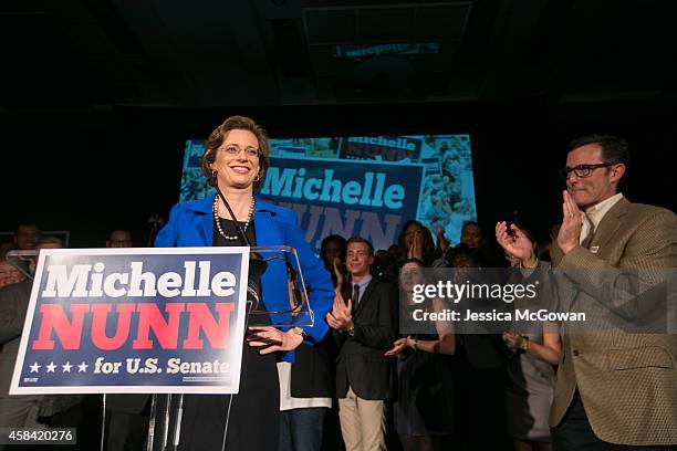 Georgia Democratic U.S. Senate candidate Michelle Nunn with husband, Ron Martin, makes a concession speech to supporters gathered at the Hyatt...