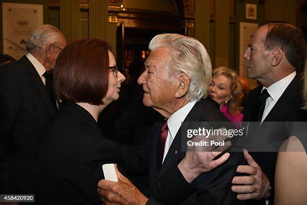 Former Prime Ministers Julia Gillard and Bob Hawke greet each other following the state memorial service for former Australian Prime Minister Gough...