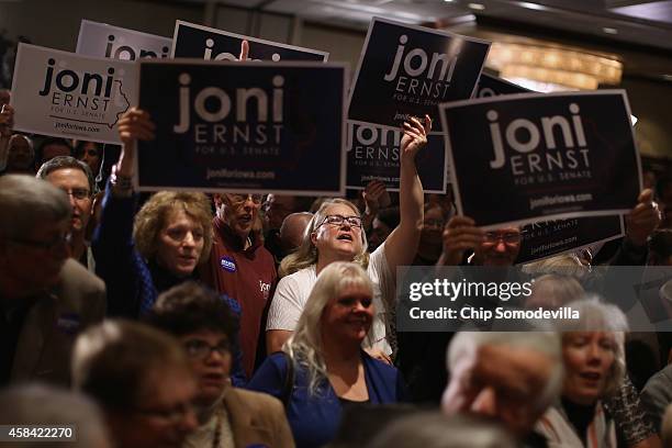 Supporters celebrate after hearing that Republican candidate Joni Ernst won the U.S. Senate race on election night at the Marriott Hotel November 4,...