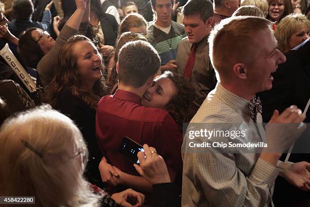 Republican U.S. Senator-elect Joni Ernst's daughter Libby Ernst hugs a friend after hearing that her mother had won the race for U.S. Senate on...