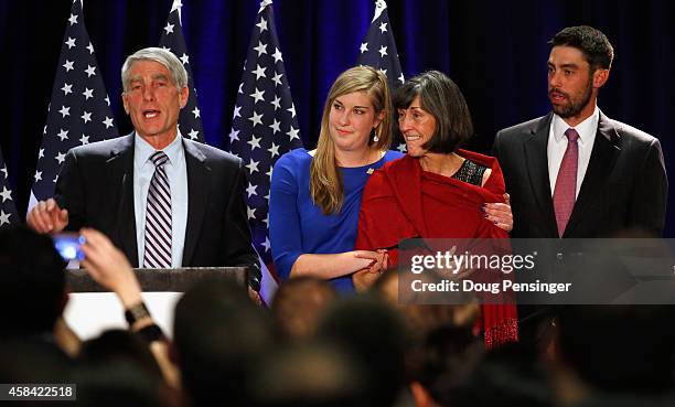 Sen. Mark Udall addresses guests at a Democratic Party election night event with his family at his side, son Jebediah Udall, wife Maggie L. Fox and...