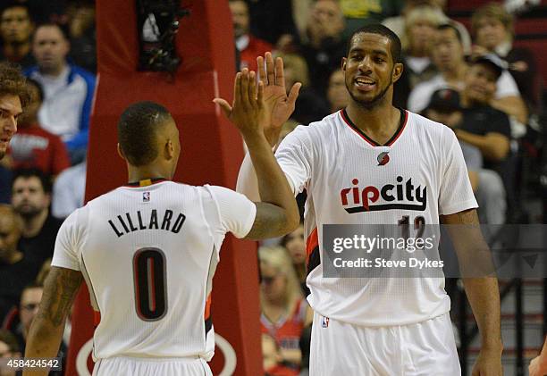 Damian Lillard of the Portland Trail Blazers celebrates a basket by LaMarcus Aldridge of the Portland Trail Blazers during the fourth quarter of the...