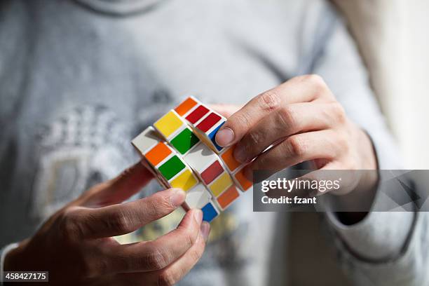 hands playing a cube game - rubiks kub bildbanksfoton och bilder