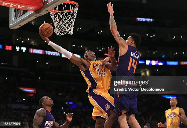 Kobe Bryant of the Los Angeles Lakers lays up a shot against Gerald Green of the Phoenix Suns in the second half during the NBA game at Staples...