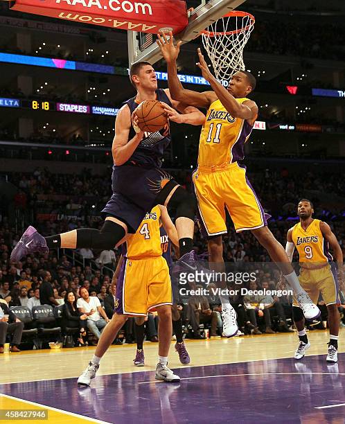 Alex Len of the Phoenix Suns looks to make a pass play against Wesley Johnson of the Los Angeles Lakers in the second period during the NBA game at...
