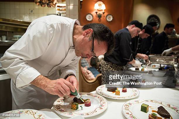 Chef Patrick Bertron, of Relais Bernard Loiseau, prepares a beef course for a gala dinner at the The Inn at Little Washington, celebrating the 60th...