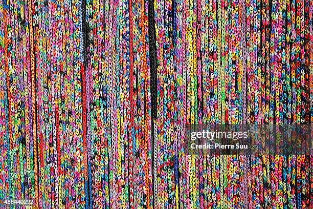 Claire's create the World's largest 'Rainbow loom' and decorate a sofa with it in front of Paris City Hall on November 5, 2014 in Paris, France.