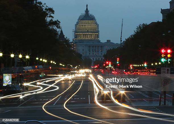 The early morning sun rises behind the US Capitol building as traffic drives down Pennsylvania Ave., November 5, 2014 in Washington, DC. Yesterday...