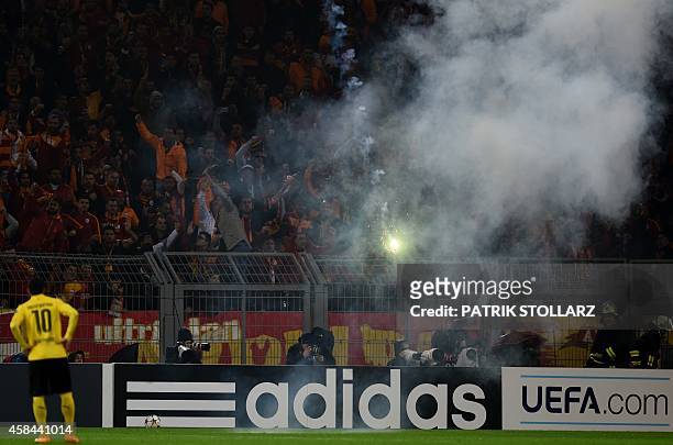 Galatasaray's supporters burn fireworks during the UEFA Champions League second-leg Group D football match Borussia Dortmund vs Galatasaray AS in...