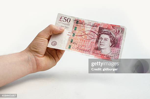 holding a 50 pound note - 50 pound notes stock pictures, royalty-free photos & images