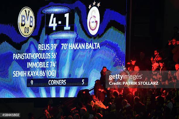 Galatasaray's supporters burn fireworks during the UEFA Champions League second-leg Group D football match Borussia Dortmund vs Galatasaray AS in...