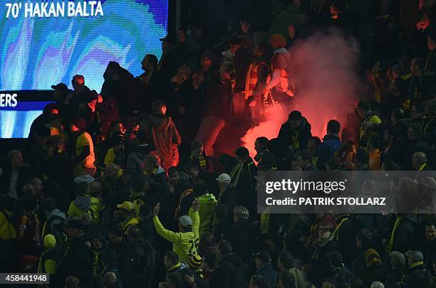 Galatasaray's supporters burn fireworks during the UEFA Champions League second-leg Group D football match Borussia Dortmund vs Galatasaray AS in...