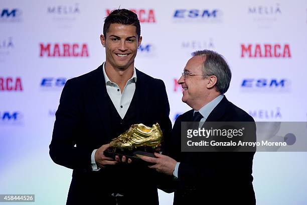 Cristiano Ronaldo of Real Madrid CF receives the Golden Boot award from president of Real Madrid CF Florentino Perez at Melia Castilla hotel on...