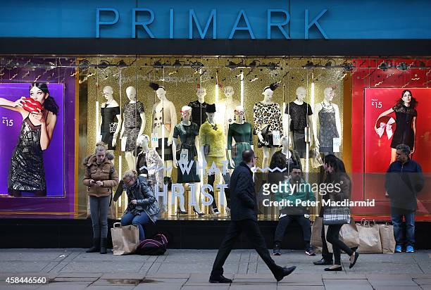 Customers wait with their purchases outside Primark's flagship store on Oxford Street on November 5, 2014 in London, England. Retail giant Marks and...